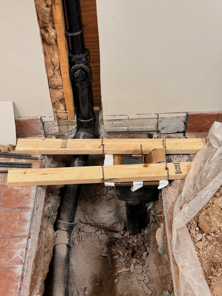 Drain and vent piping installed for a new floor sink during a commercial restaurant remodel