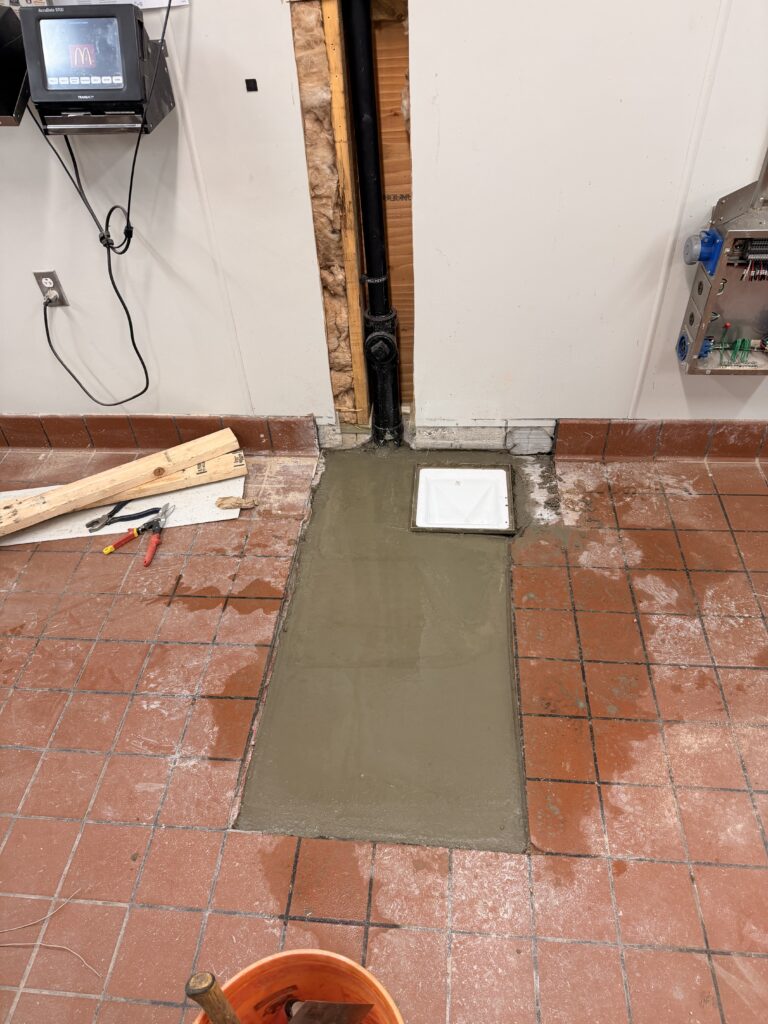 Floor sink area backfilled during a commercial restaurant plumbing remodel