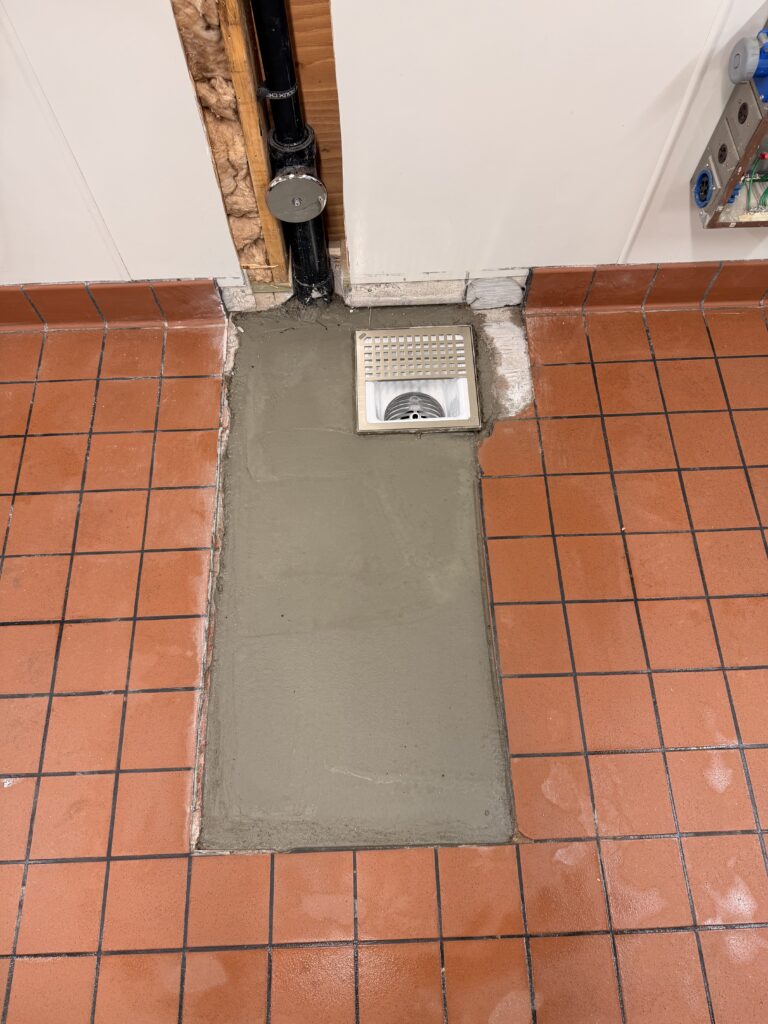Concrete restored around a new floor sink during a commercial restaurant remodel